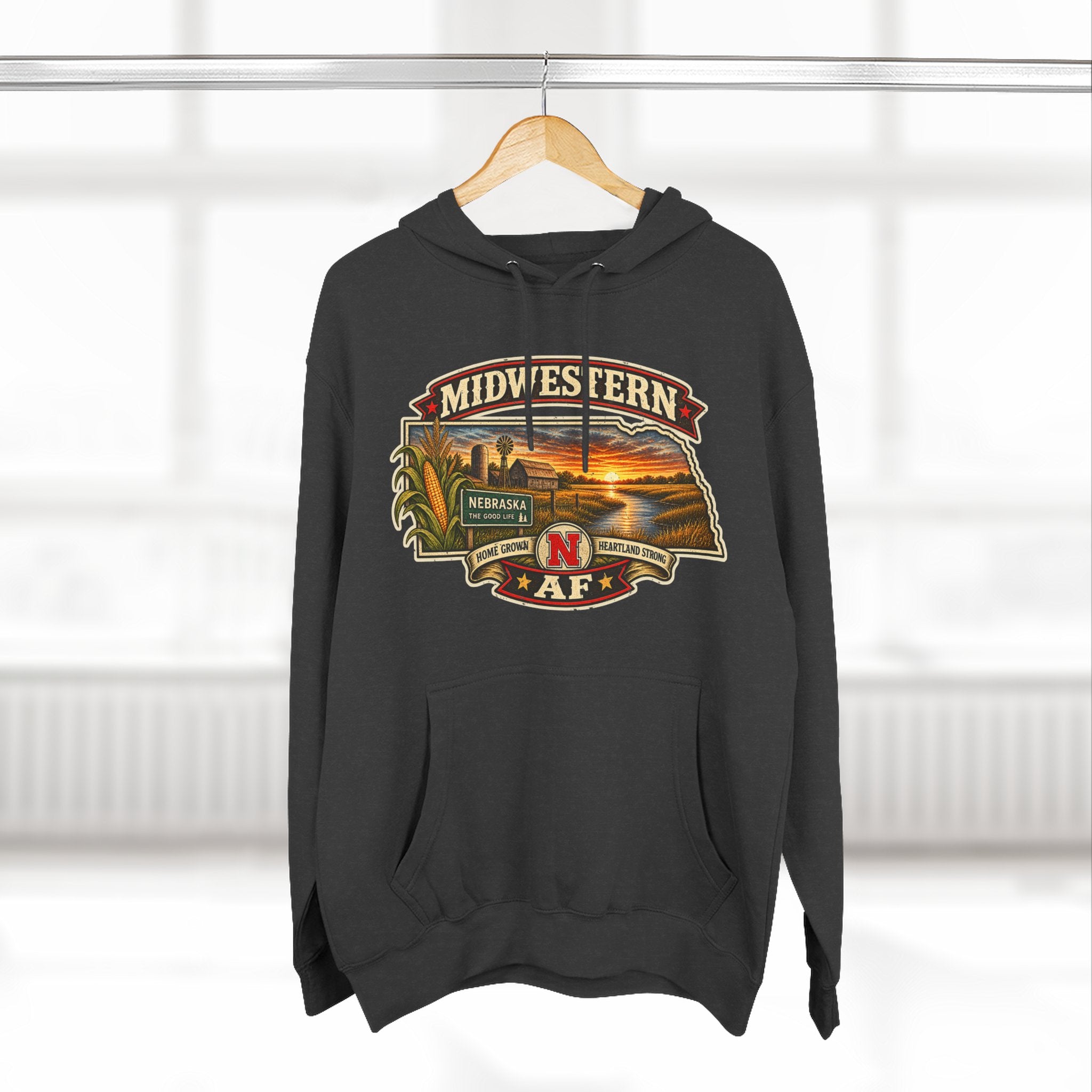 Charcoal heather Nebraska hoodie on a hanger showing the Midwestern AF front print