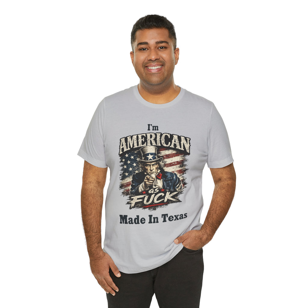 Light gray tee worn by smiling male model, Uncle Sam graphic with "I'm American As Fuck, Made In Texas" text