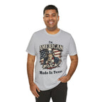 Light gray tee worn by smiling male model, Uncle Sam graphic with "I'm American As Fuck, Made In Texas" text
