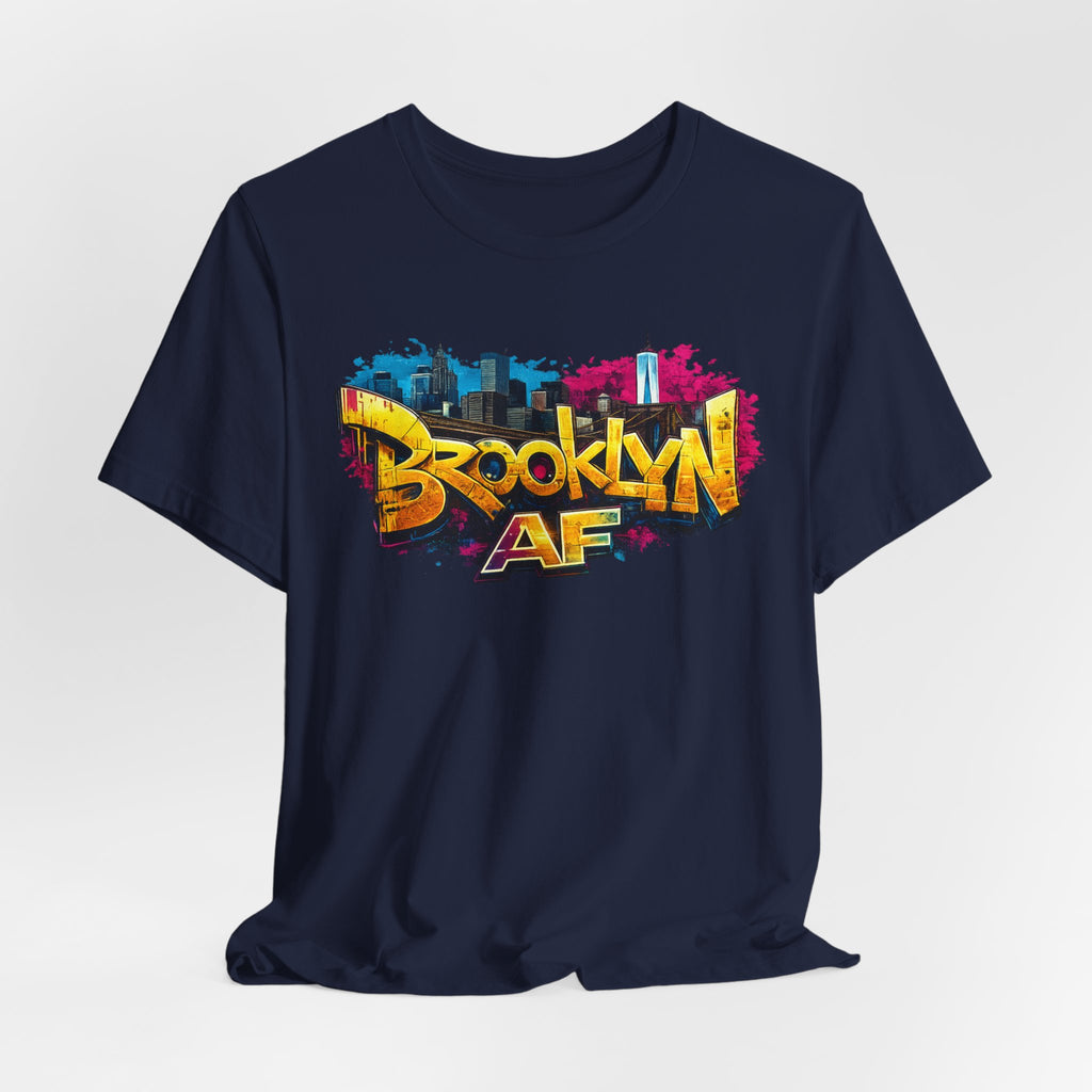 Navy t-shirt, front view flat lay, with graffiti-style Brooklyn AF lettering over a skyline paint-splash design.