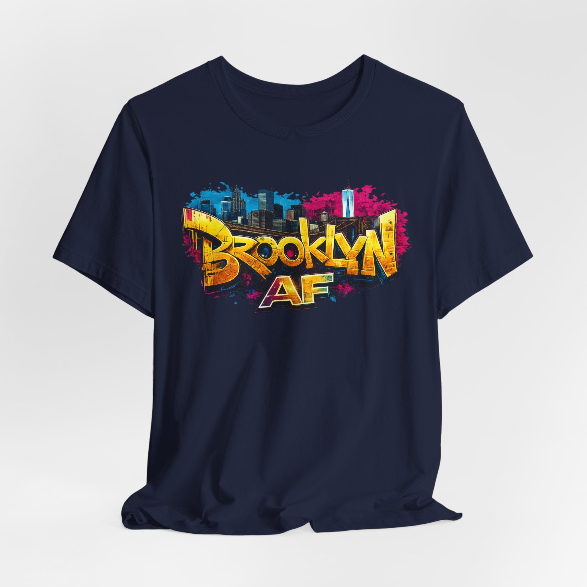 Navy t-shirt, front view flat lay, with graffiti-style Brooklyn AF lettering over a skyline paint-splash design.