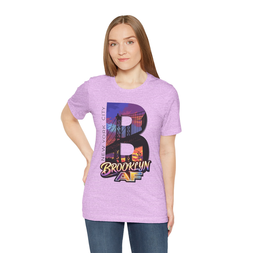 Heather Prism Lilac tee worn by a female model, front view, with the "B" Brooklyn Bridge sunset skyline graphic.