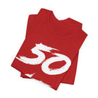 Folded red birthday tees stacked with the white 50 print across the top fold