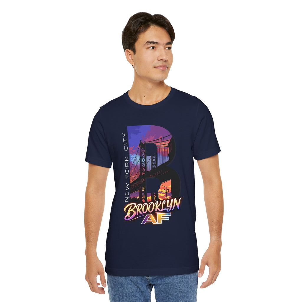 Navy t-shirt worn by a model, front view showing the full 'B' Brooklyn Bridge sunset skyline graphic and logo