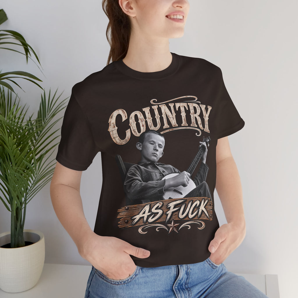 Woman by a houseplant in the Dark Chocolate Country As Fuck tee