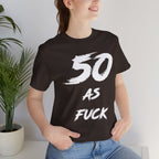 Close view of a woman in the dark brown 50 AS FUCK tee, photographed indoors by a plant