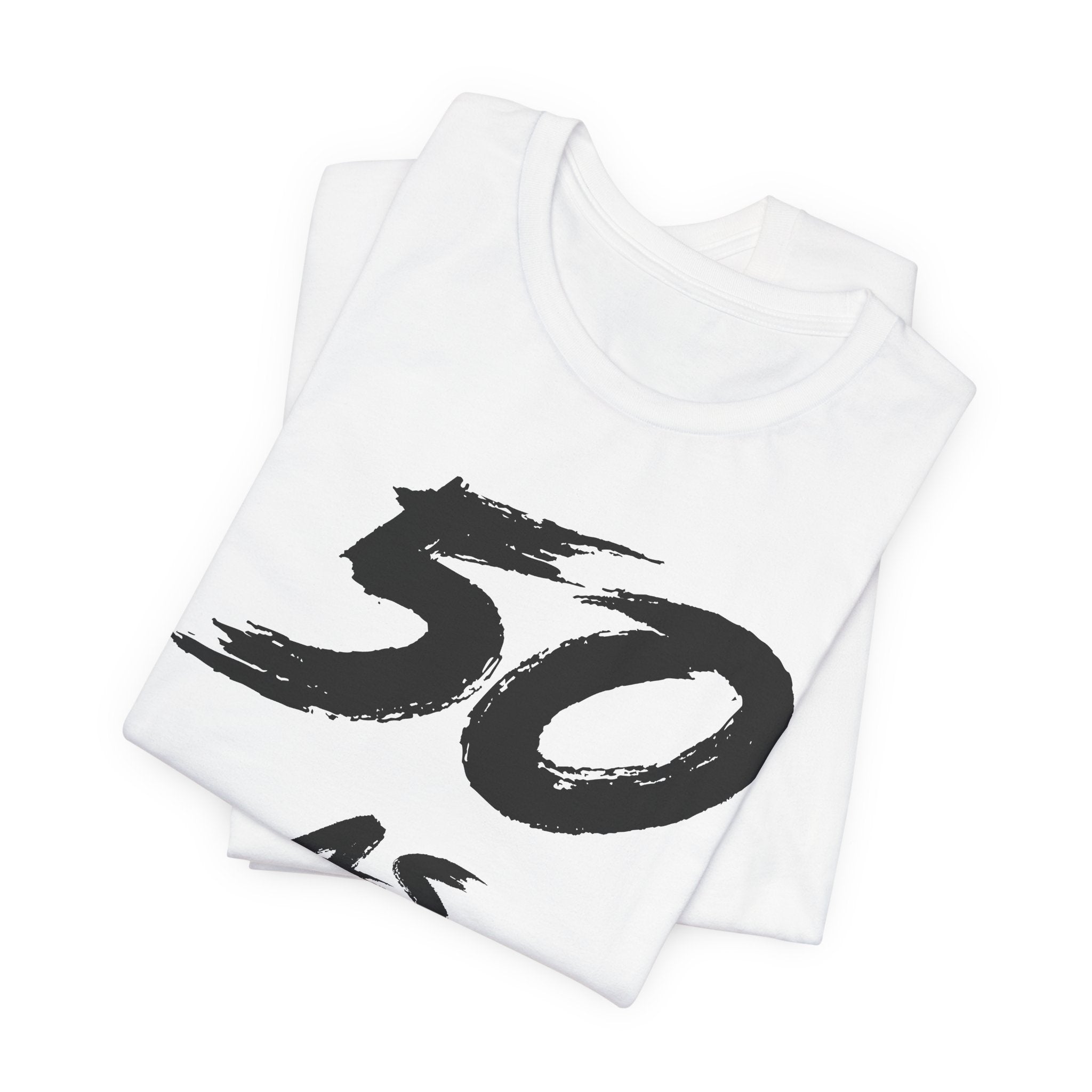 Folded white birthday tees stacked, the black 50 showing on the top fold
