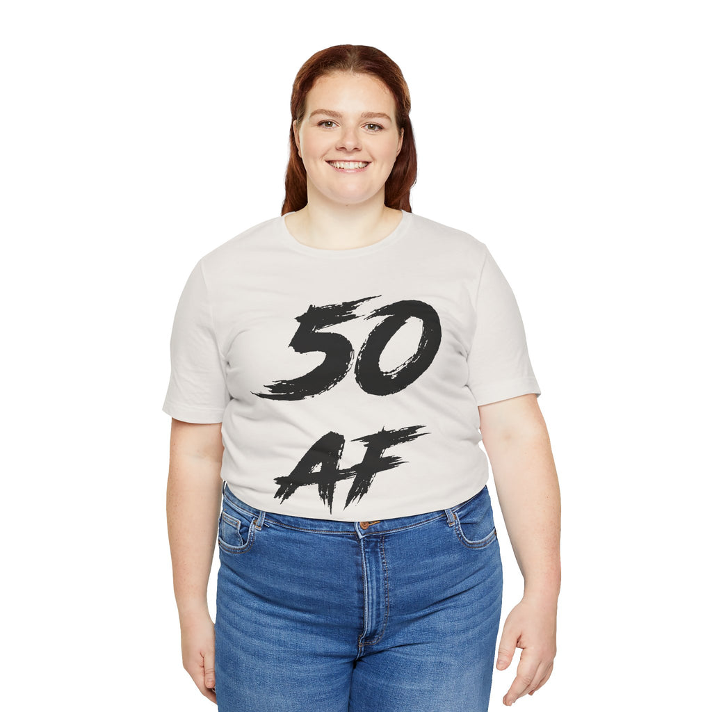 Smiling woman wearing the Vintage White 50 AF birthday tee with jeans