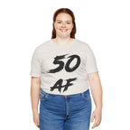 Smiling woman wearing the Vintage White 50 AF birthday tee with jeans