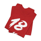 Folded red birthday tees stacked with the white 18 across the top fold