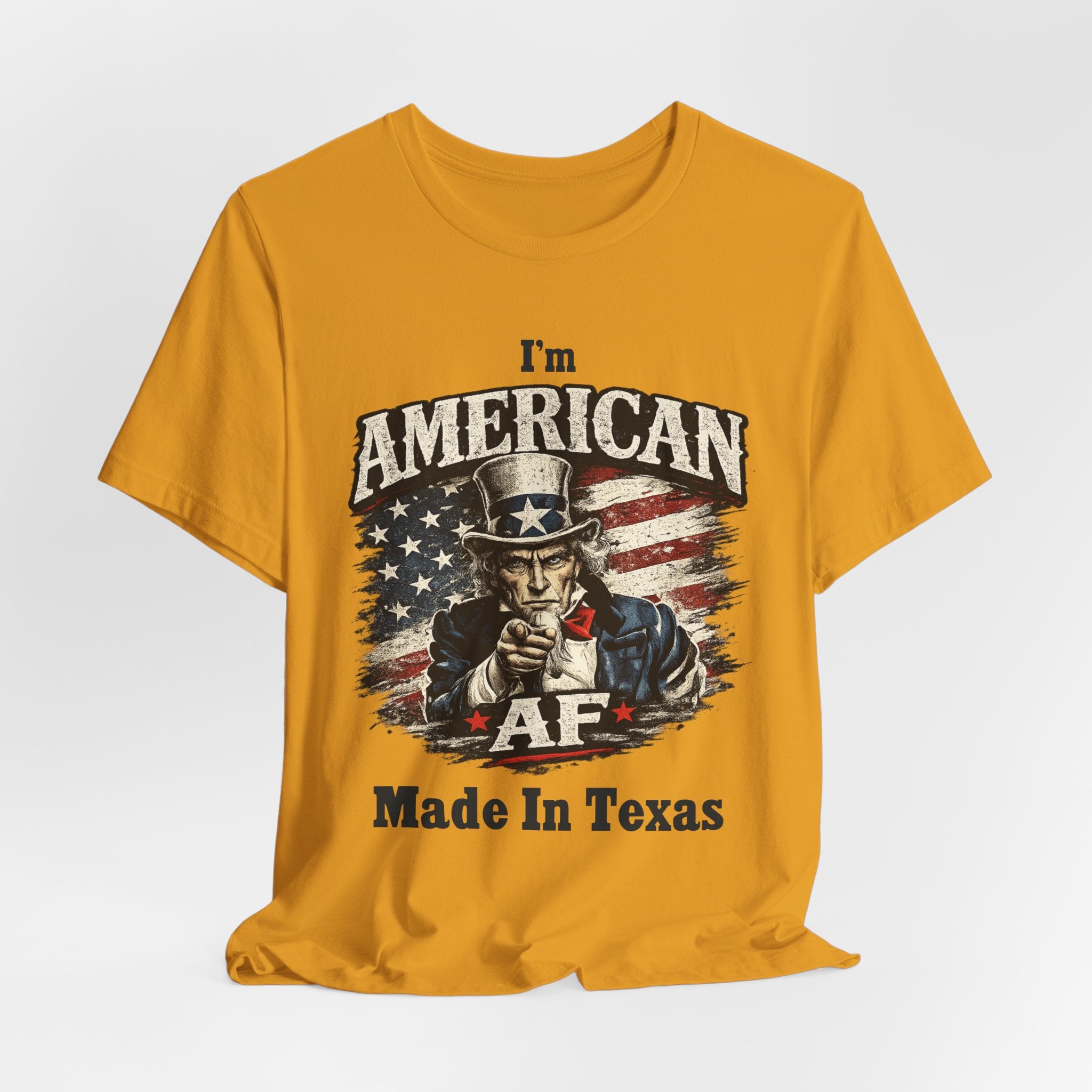 Mustard yellow flat lay tee with the Uncle Sam pointing graphic and 'Made In Texas' text