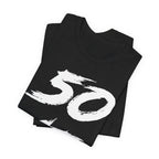 Folded black birthday tees stacked, the white 50 print filling the top fold