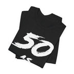 Folded black birthday tees stacked, the white 50 filling the top fold
