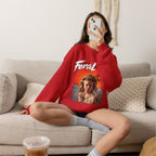 Woman sitting on a sofa in the Red Feral AF crewneck, the fiery print facing the camera