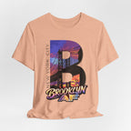 Heather Peach tee on a mannequin torso, front view, showing the "B" Brooklyn Bridge sunset skyline graphic and logo.