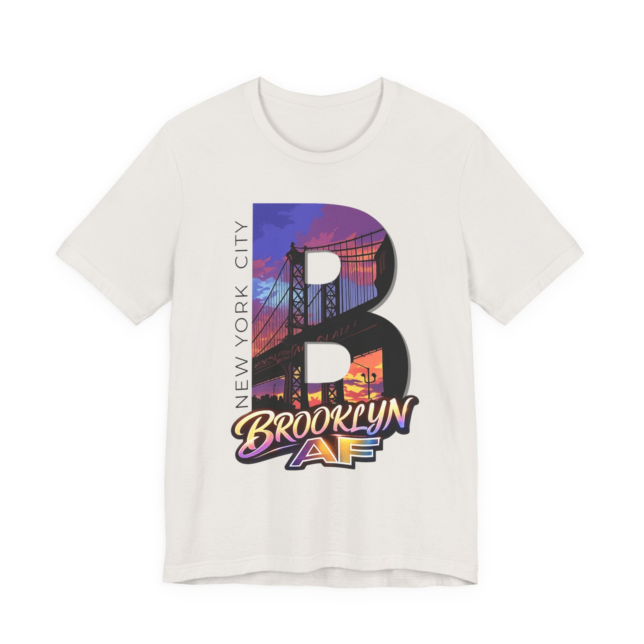 Vintage white t-shirt, flat lay, with a bold oversized "B" featuring a Brooklyn Bridge sunset skyline graphic.