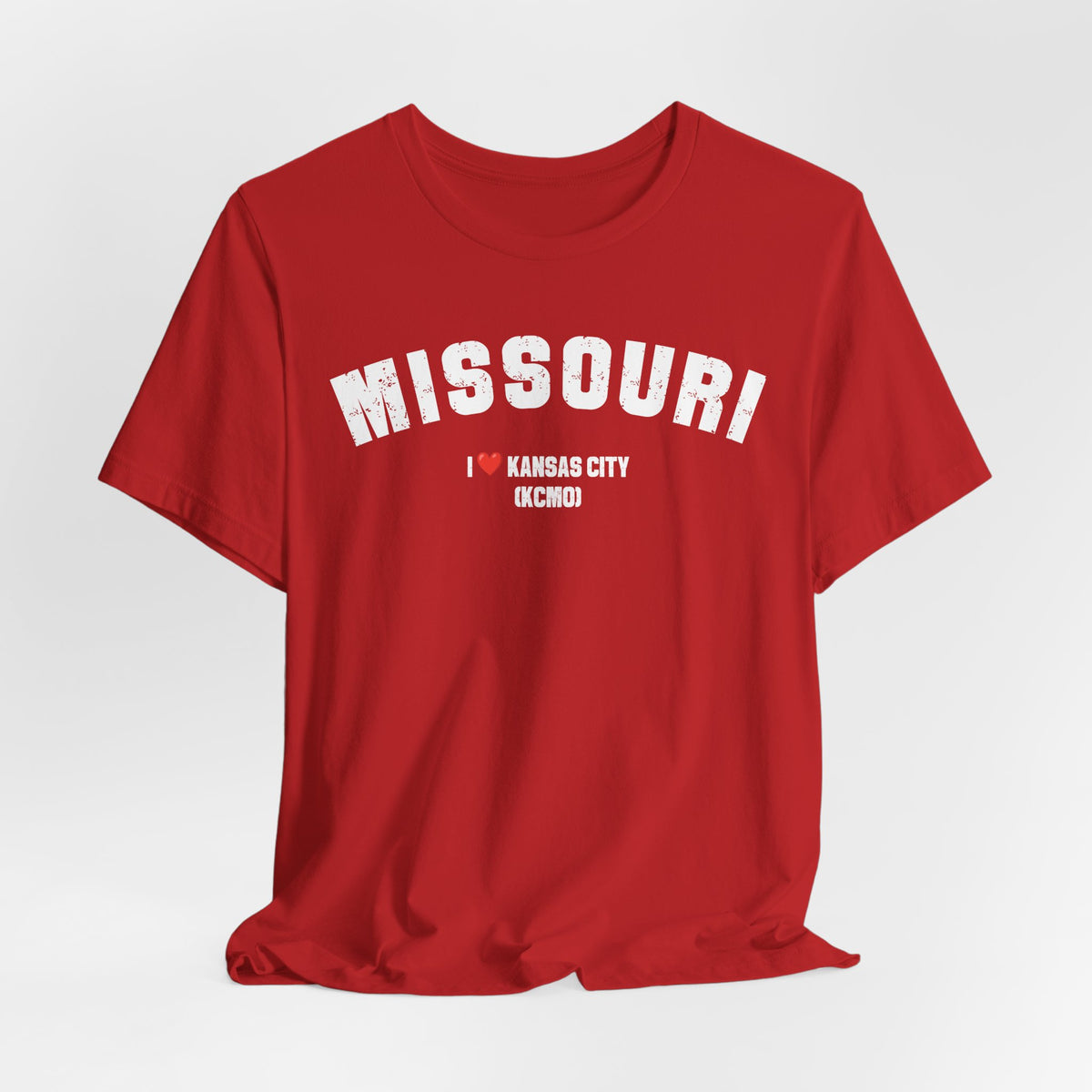 Red custom Missouri t-shirt draped on grey, white varsity MISSOURI lettering above I heart KANSAS CITY