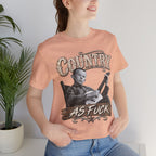 Woman beside a plant in the Heather Peach Country As Fuck tee