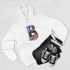White hoodie styled with black jeans, belt, and sneakers, bold B showing a Brooklyn Bridge sunset skyline graphic.