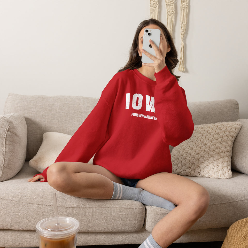 Woman relaxing on a sofa in the red personalized Iowa sweatshirt with varsity IOWA lettering