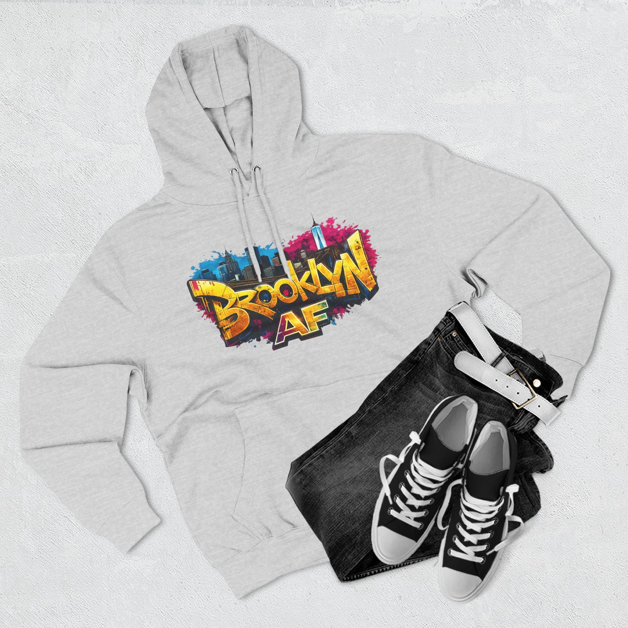 Heather Grey hoodie flat lay styled with black jeans and sneakers, showing the graffiti-style Brooklyn AF skyline print.