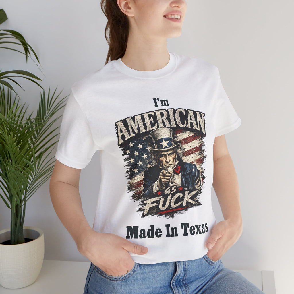 White tee worn by female model, close-up, Uncle Sam graphic with "I'm American As Fuck, Made In Texas" text
