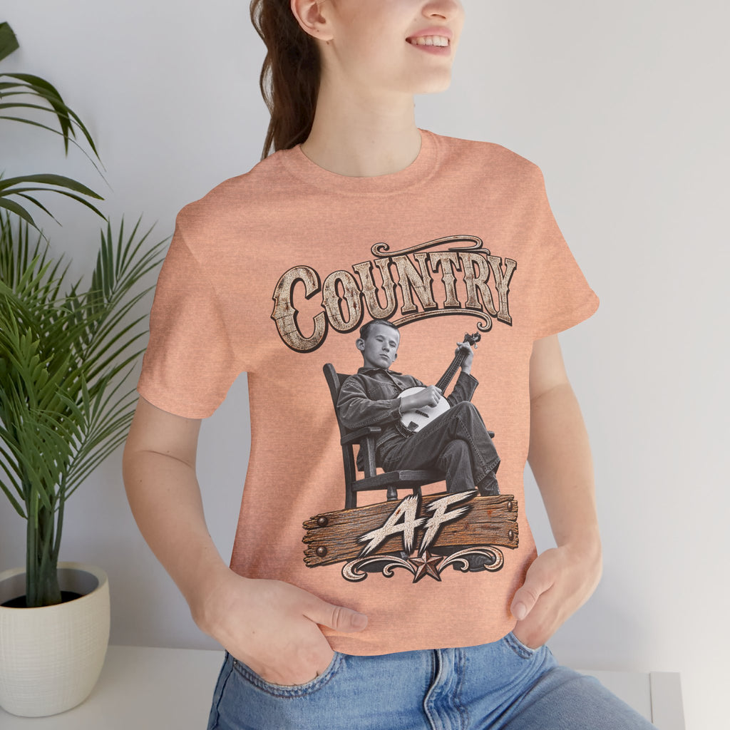 Woman beside a plant in the Heather Peach Country AF tee
