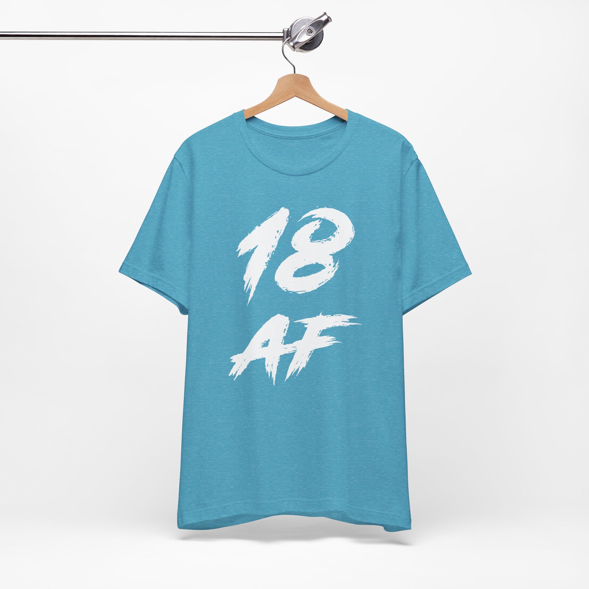 Heather Aqua birthday tee hanging on a hanger, white 18 AF graphic facing front