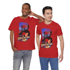 Red t-shirts worn by two male models, front view, each with a bold "B" Brooklyn Bridge sunset skyline graphic.