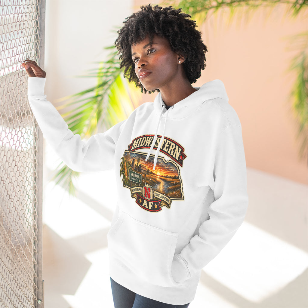 Woman in the white Nebraska hoodie outdoors, showing the front sunset graphic