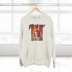 Oatmeal Heather Feral AF pullover on a wooden hanger by a window, front print facing the camera