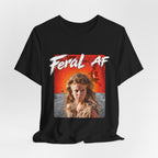Black Feral AF tee styled loosely on a studio surface, showing the drape and the front print