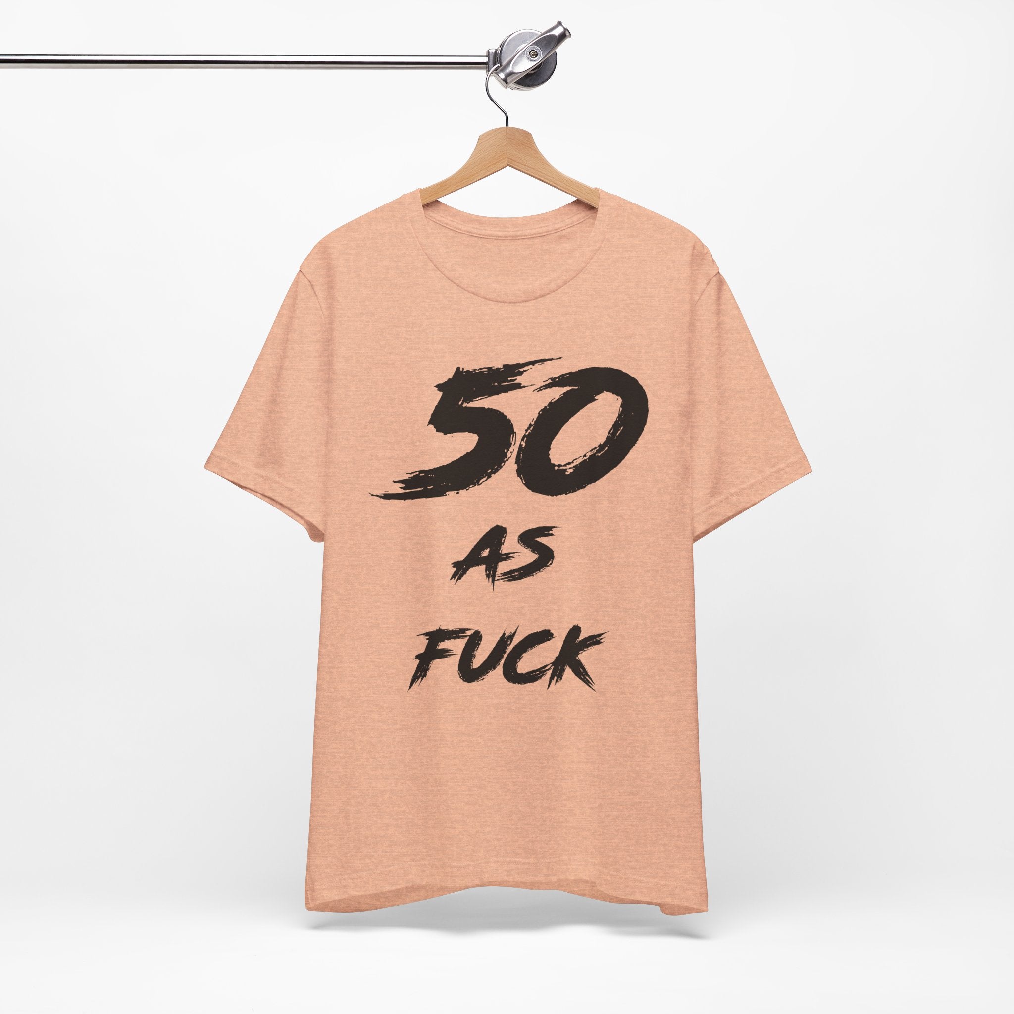 Heather Peach birthday tee on a wooden hanger showing the black front print