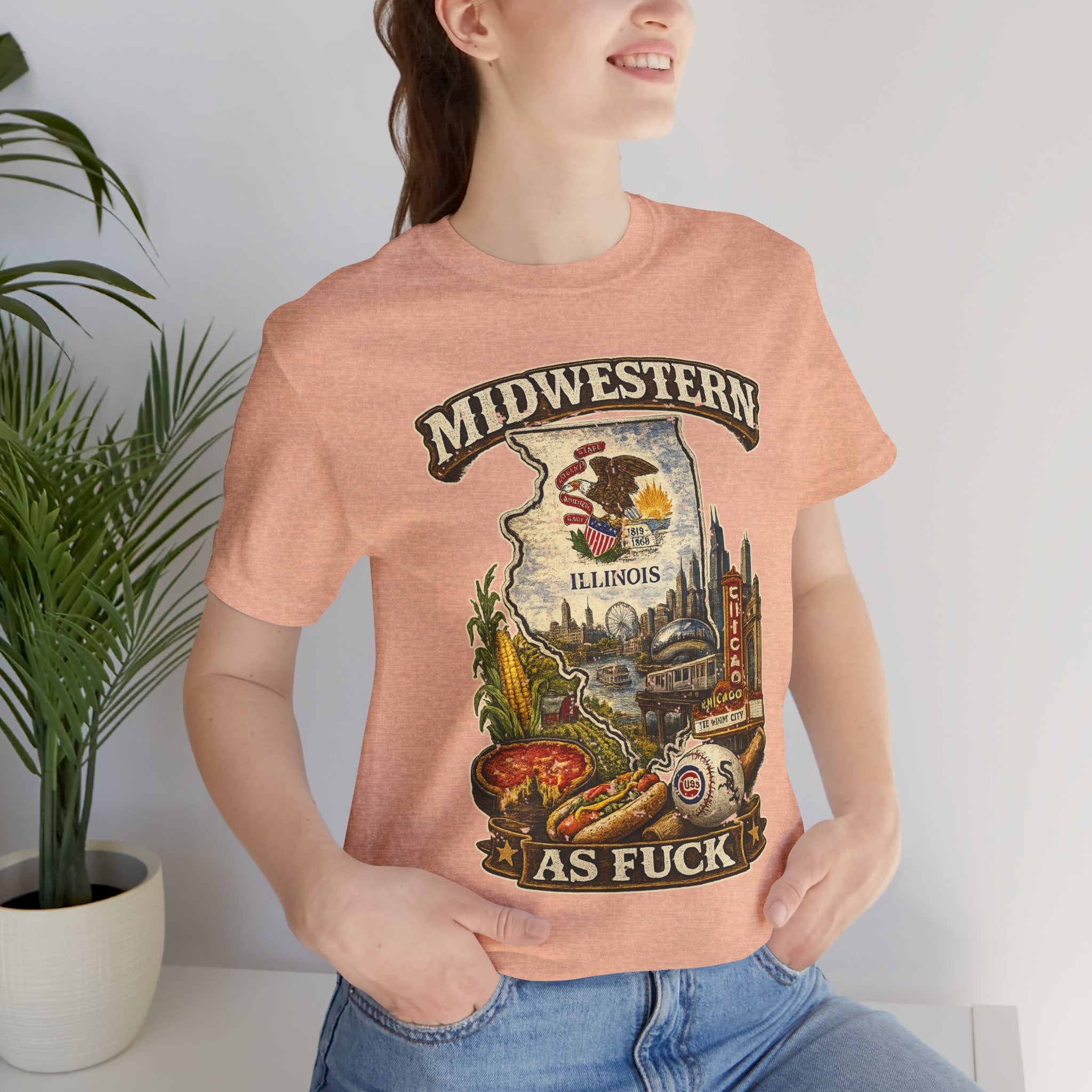 Midwestern As Fuck Illinois T-Shirt – product photo 9 featuring a distressed vintage design featuring the Illinois state outline overlaid with the state flag, surrounded by the Chicago skyline, the Chicago Theatre sign, The Bean, deep-dish pizza, a Chicago-style hot dog, and towering corn fields