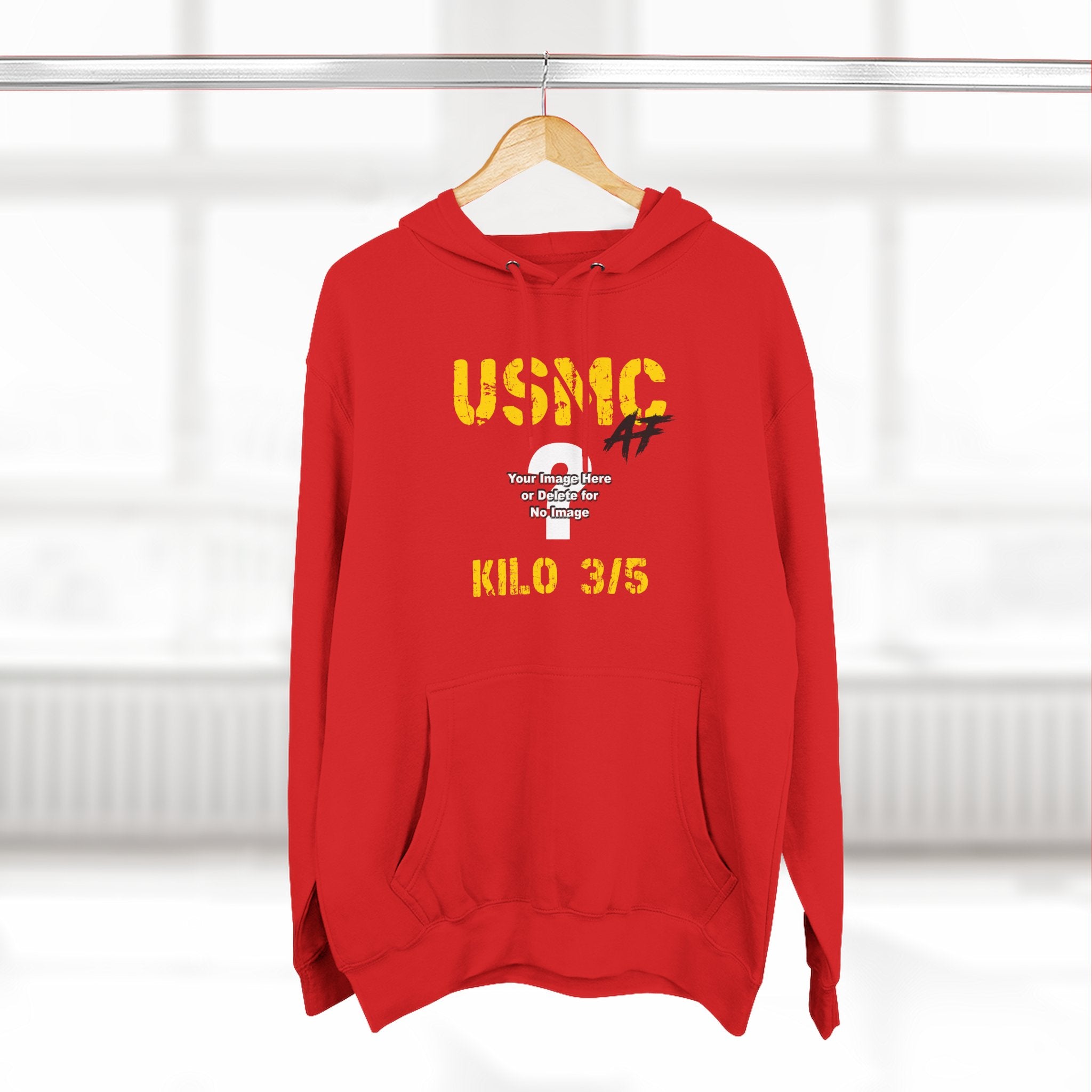 Personalized USMC Marine Corps AF hoodie in Red on a wooden hanger in a bright room