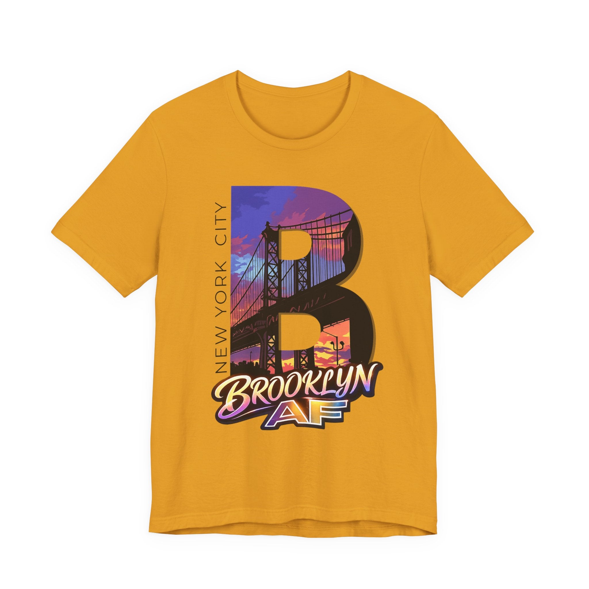 Mustard yellow t-shirt, flat lay, with a bold oversized "B" featuring a Brooklyn Bridge sunset skyline graphic.