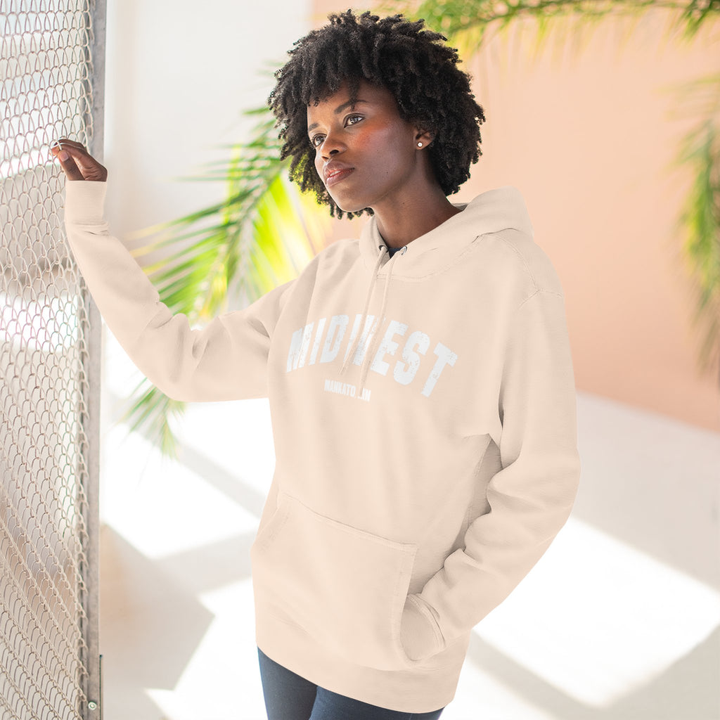 Woman leaning by a window in the Pale Pink personalized Midwest hoodie