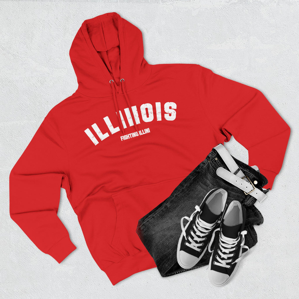 Red Illinois hoodie styled flat with jeans and sneakers, white varsity ILLINOIS above a custom line
