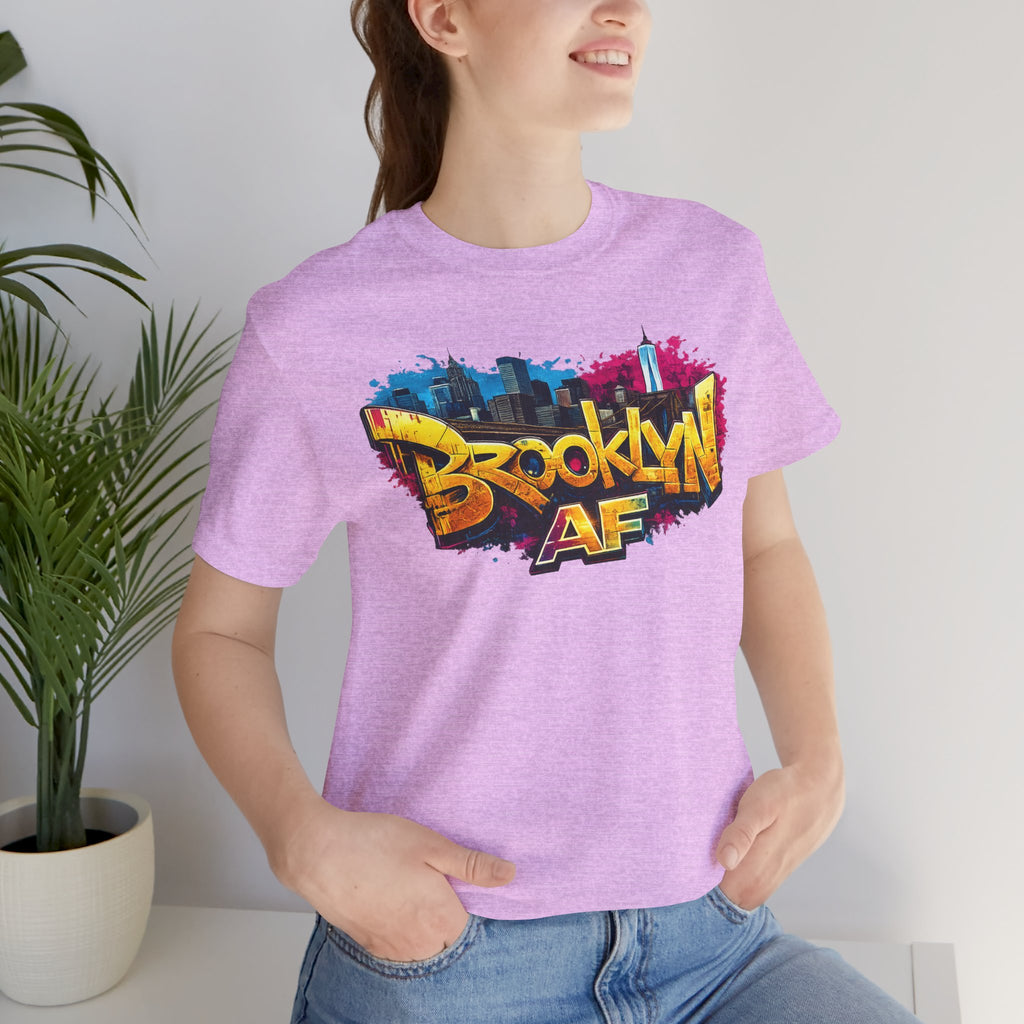 Heather Prism Lilac t-shirt worn by a model, close-up of chest print showing graffiti Brooklyn AF lettering and skyline.