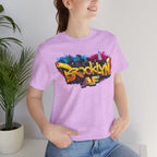 Heather Prism Lilac t-shirt worn by a model, close-up of chest print showing graffiti Brooklyn AF lettering and skyline.