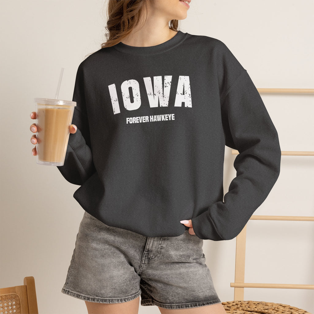 Woman with an iced coffee wearing the dark heather Iowa sweatshirt reading IOWA FOREVER HAWKEYE