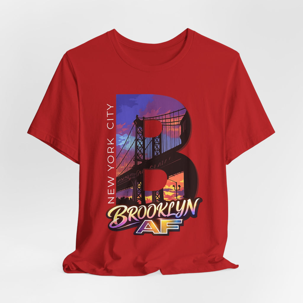 Red t-shirt flat lay, front view with full 'B' graphic, Brooklyn Bridge sunset skyline and 'Brooklyn AF' logo