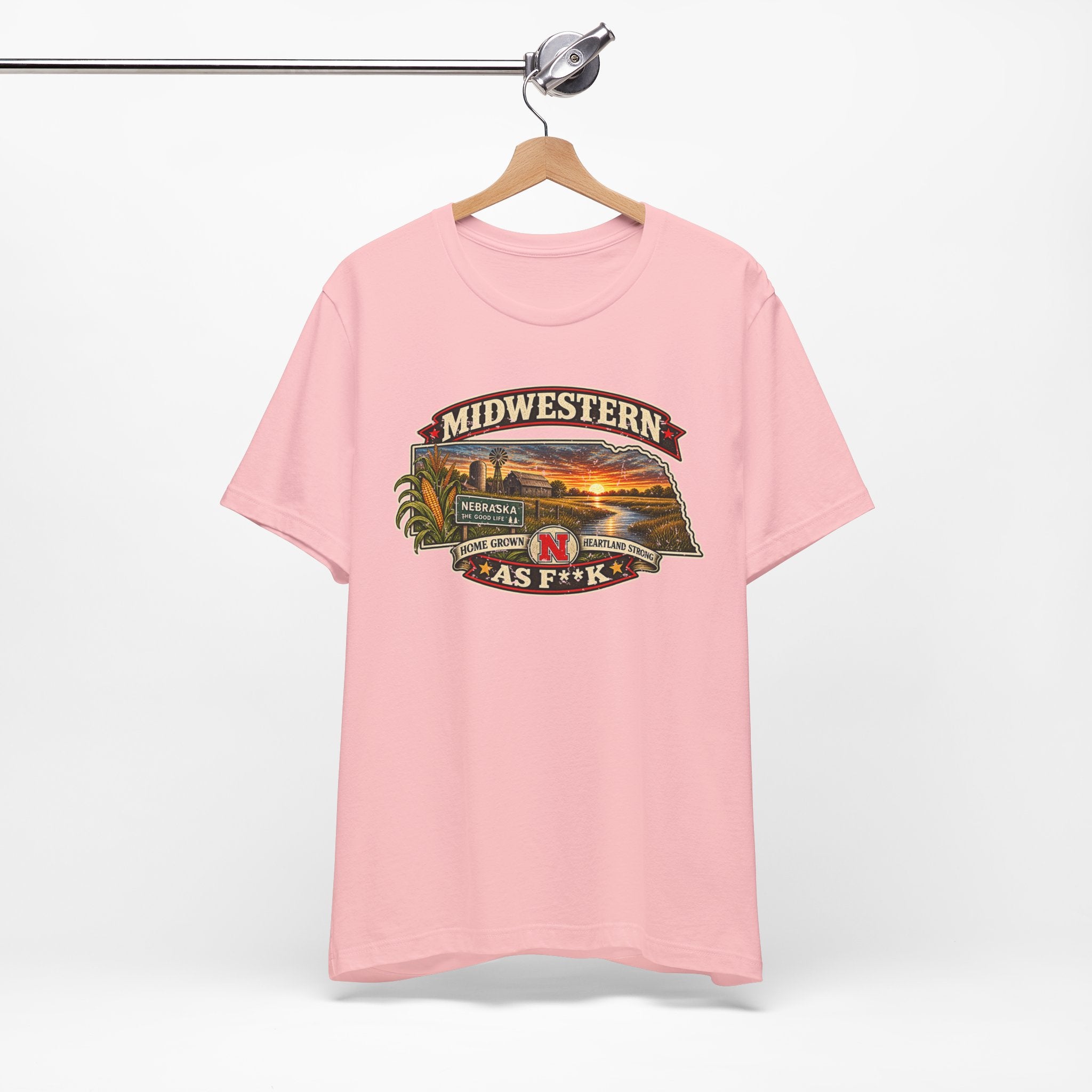 Pink Nebraska As F**K T-shirt hanging on a wooden hanger