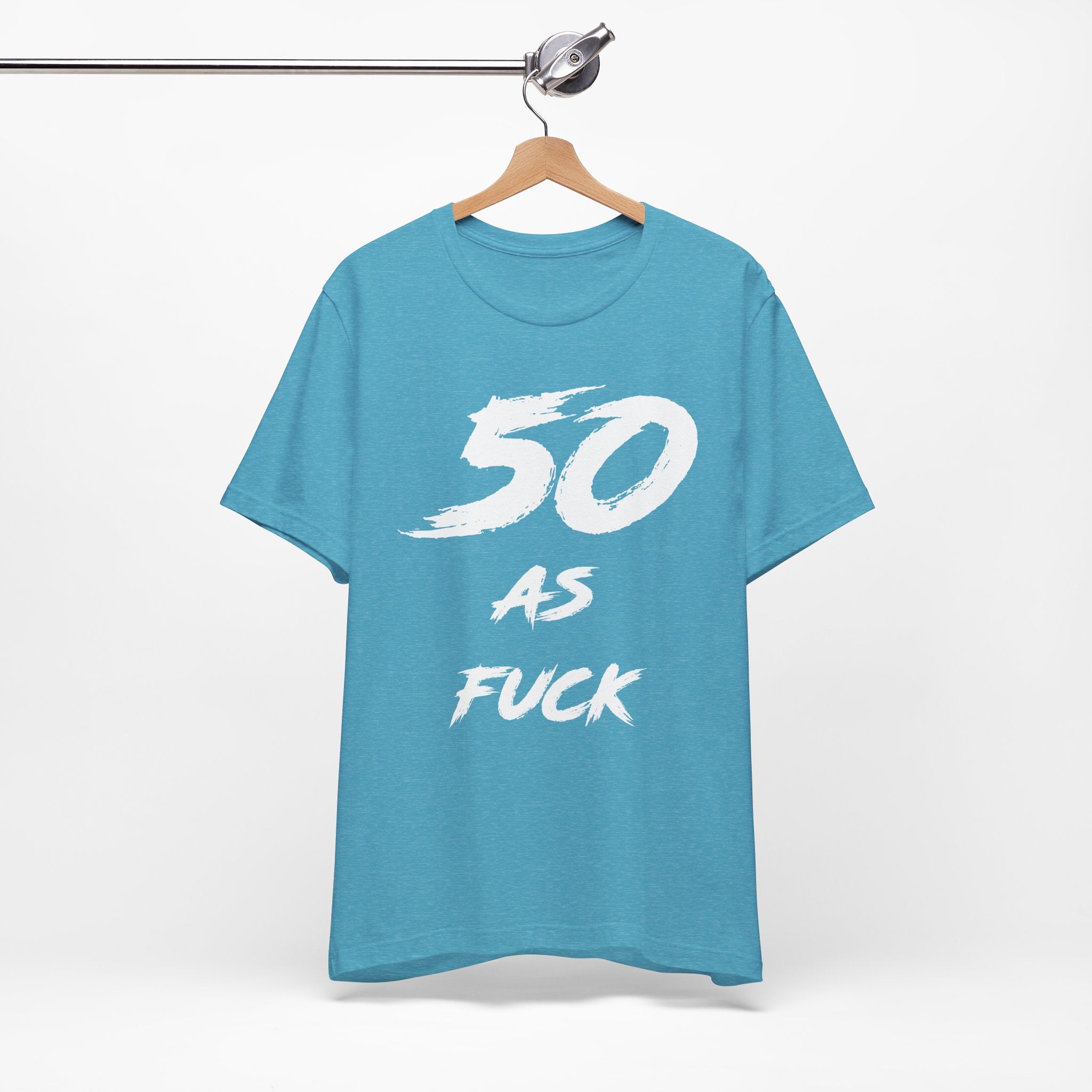 Heather Aqua birthday tee hanging on a hanger, white 50 AS FUCK graphic facing front