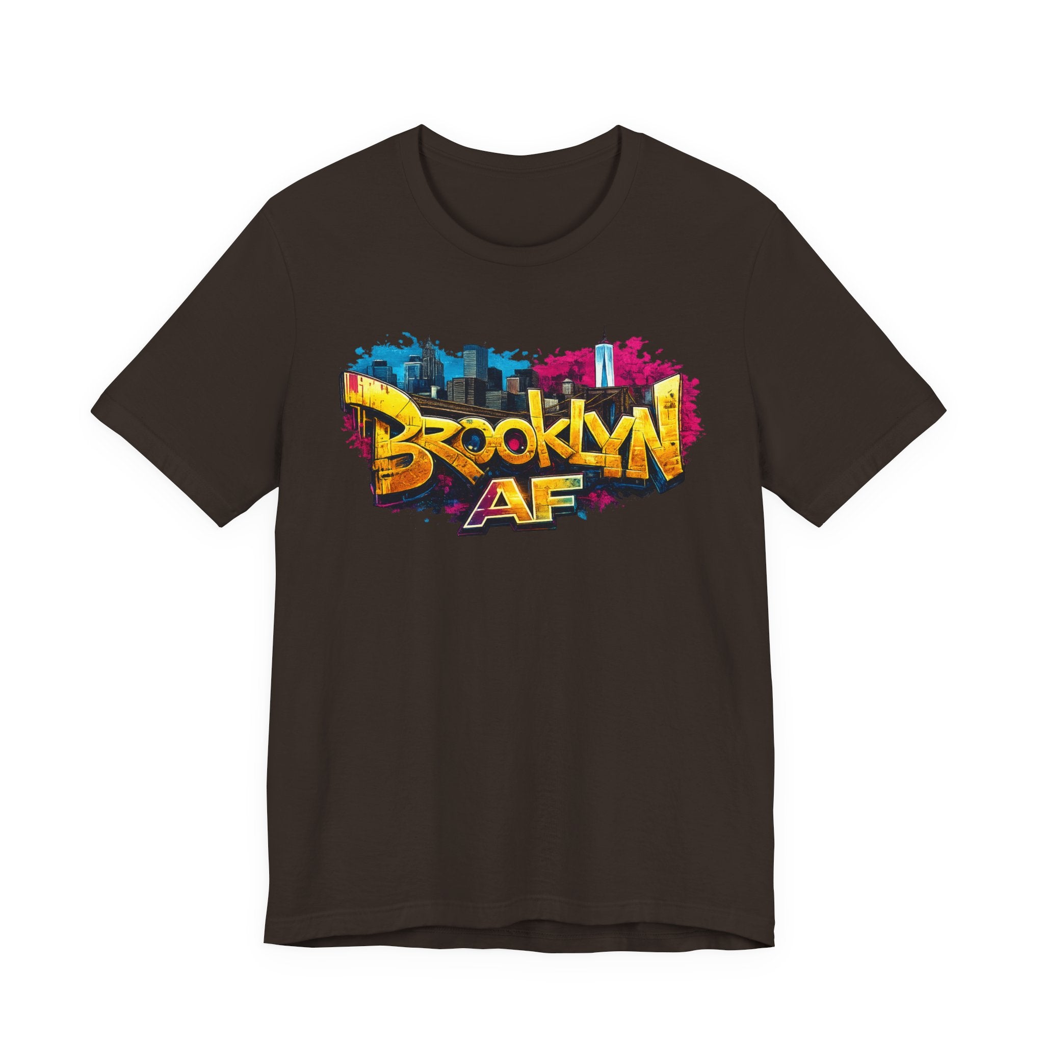 Brown t-shirt, front view flat lay, with graffiti-style Brooklyn AF lettering over a skyline and paint-splash design.