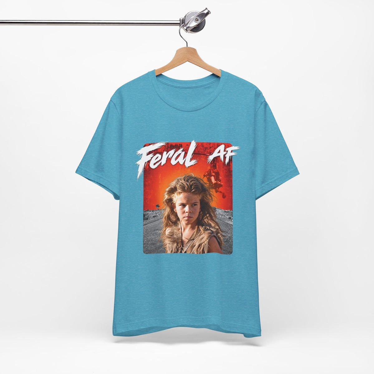 Heather Aqua Feral AF T-shirt on a wooden hanger, turquoise fabric carrying the wasteland graphic