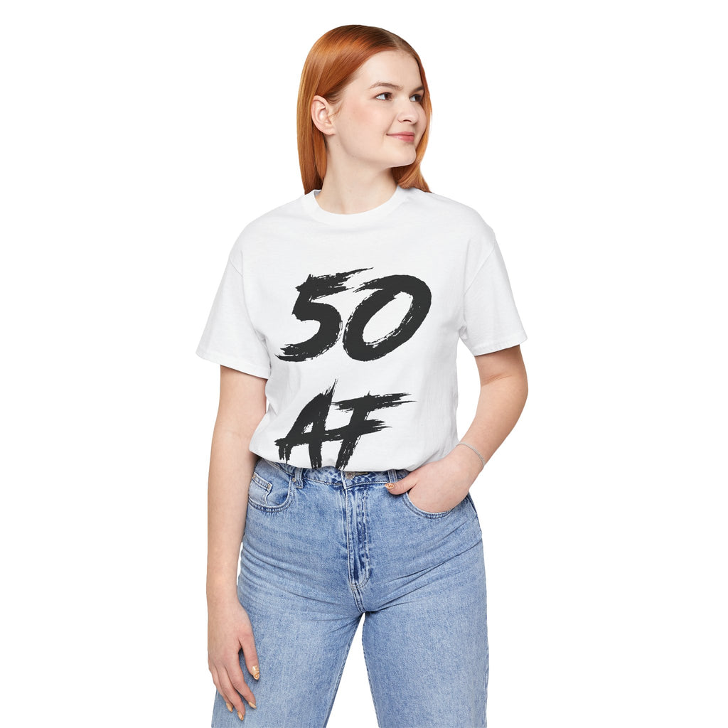 Woman wearing the white 50 AF birthday tee with blue jeans