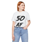 Woman wearing the white 50 AF birthday tee with blue jeans