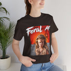 Woman wearing the Brown Feral AF T-shirt indoors beside a potted palm, front print at chest height