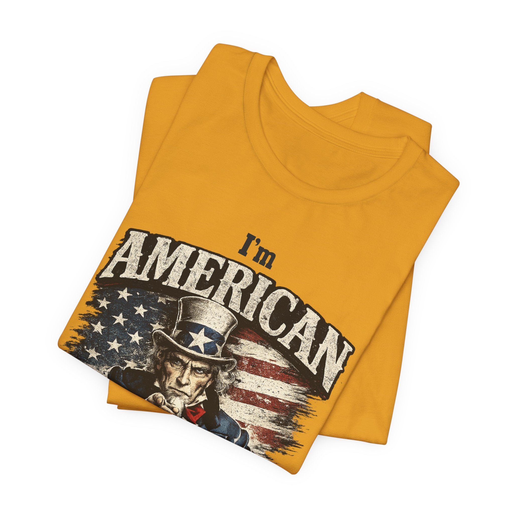 Mustard folded tee close-up showing top of Uncle Sam graphic and "I'm American" text